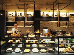 A bakery display case with various pastries and cakes. - Hilton Osaka (Osaka)