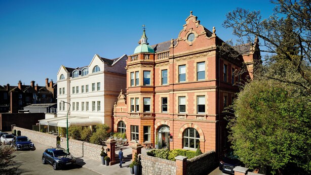 A historic building with a prominent tower and arched windows.