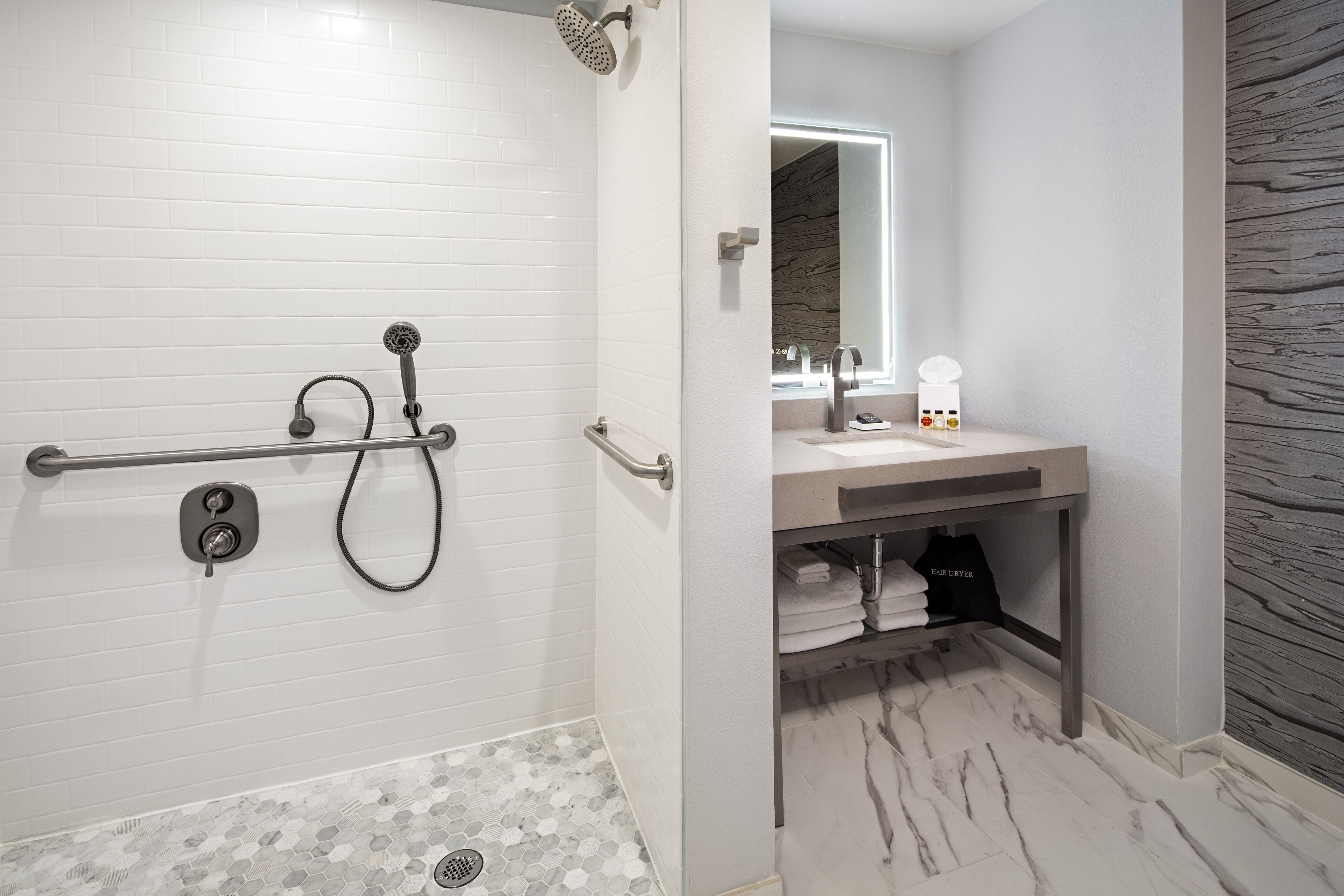 combined shower/bathtub, designer toiletries, hair dryer, towels