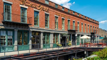 A brick building with green windows and a sign that reads "River Street Place."