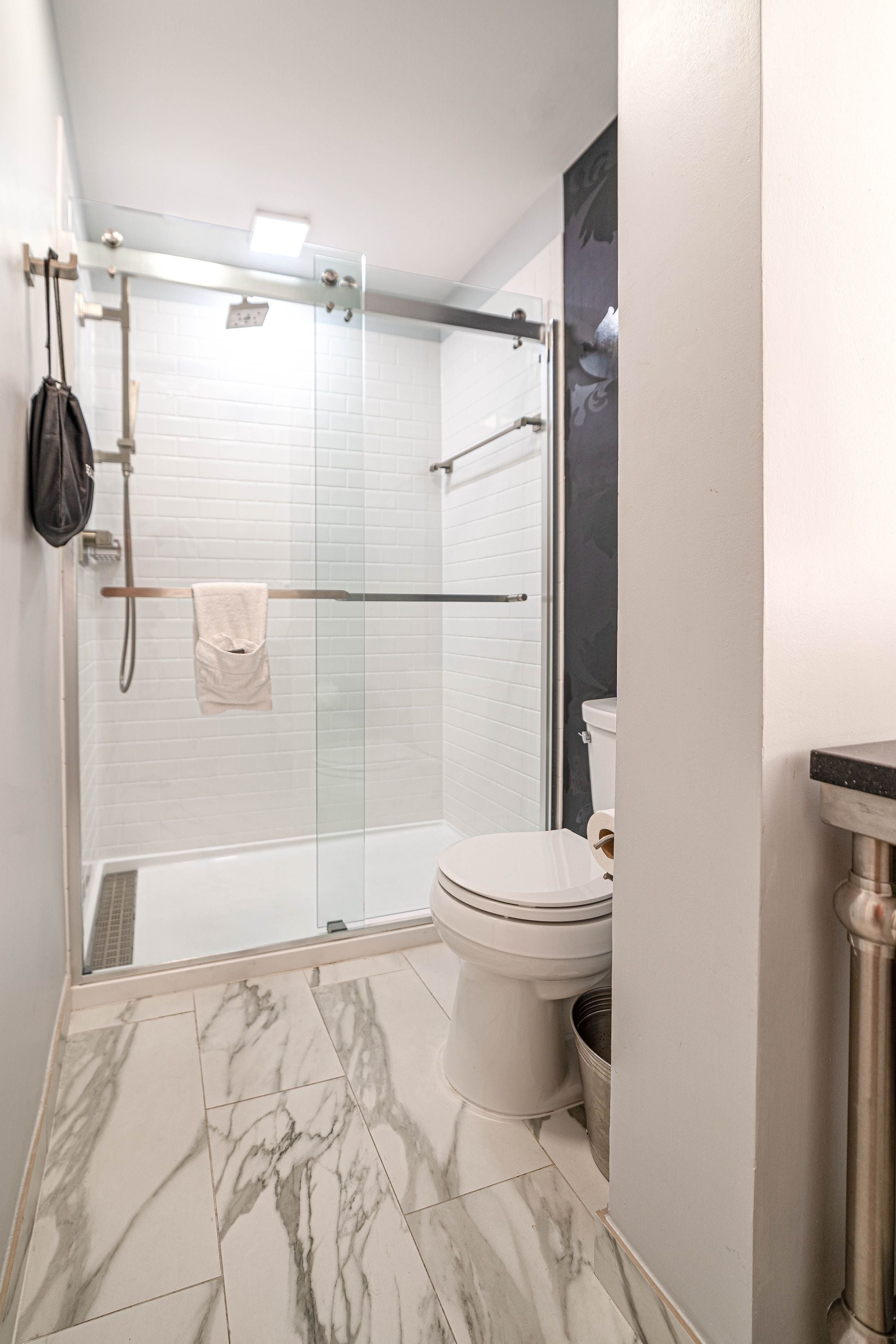 combined shower/bathtub, designer toiletries, hair dryer, towels