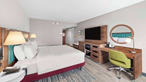 A hotel room with a bed, desk, chair, TV, and a mirror. - Hampton Inn by Hilton Los Angeles Airport LAX (Inglewood)