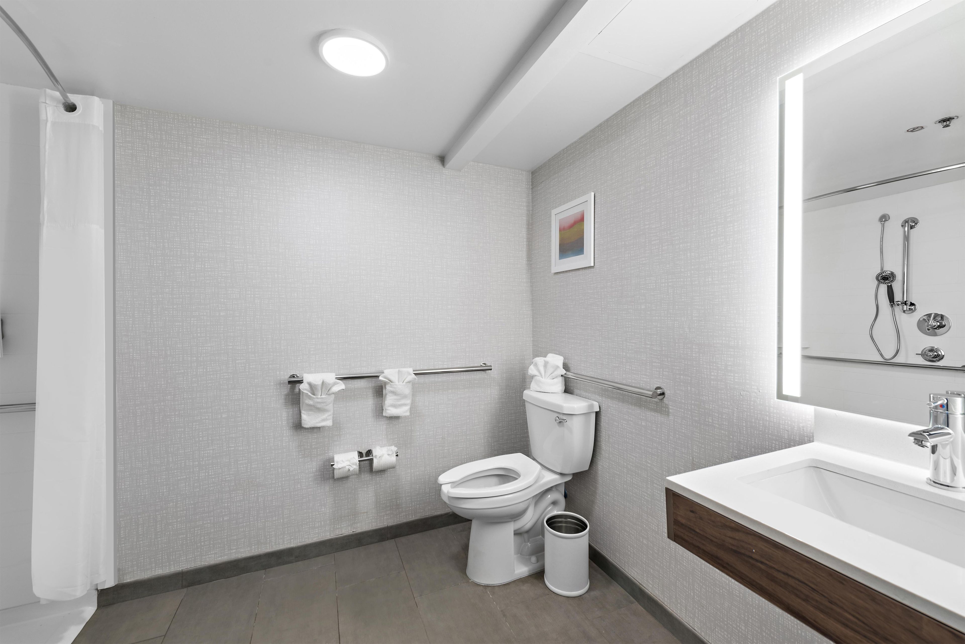 A modern bathroom with a toilet, bidet, and sink.