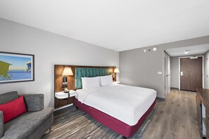 A hotel room with a bed, bedside tables, a desk, a chair, and a painting on the wall. - Hampton Inn by Hilton Los Angeles Airport LAX (Inglewood)
