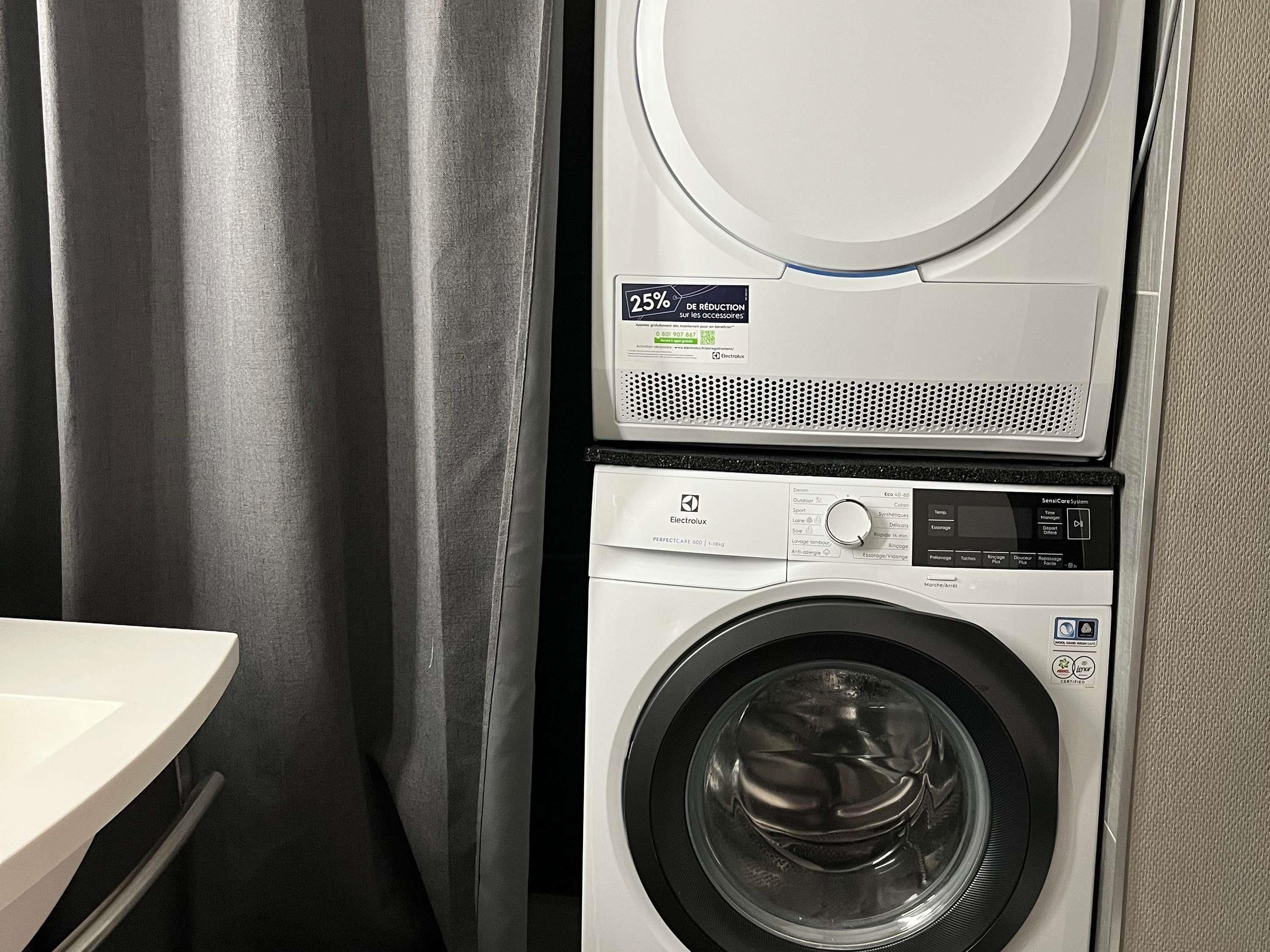 A compact washer and dryer unit with a control panel and a 25% reduction sticker.