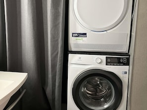 A compact washer and dryer unit with a control panel and a 25% reduction sticker. - ibis Paris Nord Villepinte parc des Expositions (Villepinte)