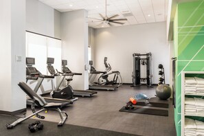 A gym with treadmills, exercise bikes, free weights, and a weight machine. - Holiday Inn Phoenix-Mesa/Chandler by IHG (Mesa)