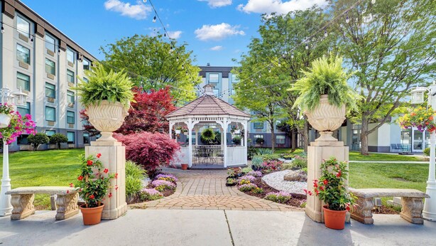 A gazebo with a tiled roof, surrounded by a garden with various plants and flowers. - Holiday Inn Piscataway Somerset by IHG (Piscataway)
