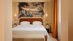 A hotel room with a large bed, two bedside tables, a headboard with a mural, and a window with curtains. - Palazzo Monnalisa (Florence)