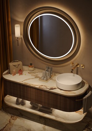 A modern bathroom with a round mirror, a white sink, and a towel rack. - Palazzo Monnalisa (Florence)