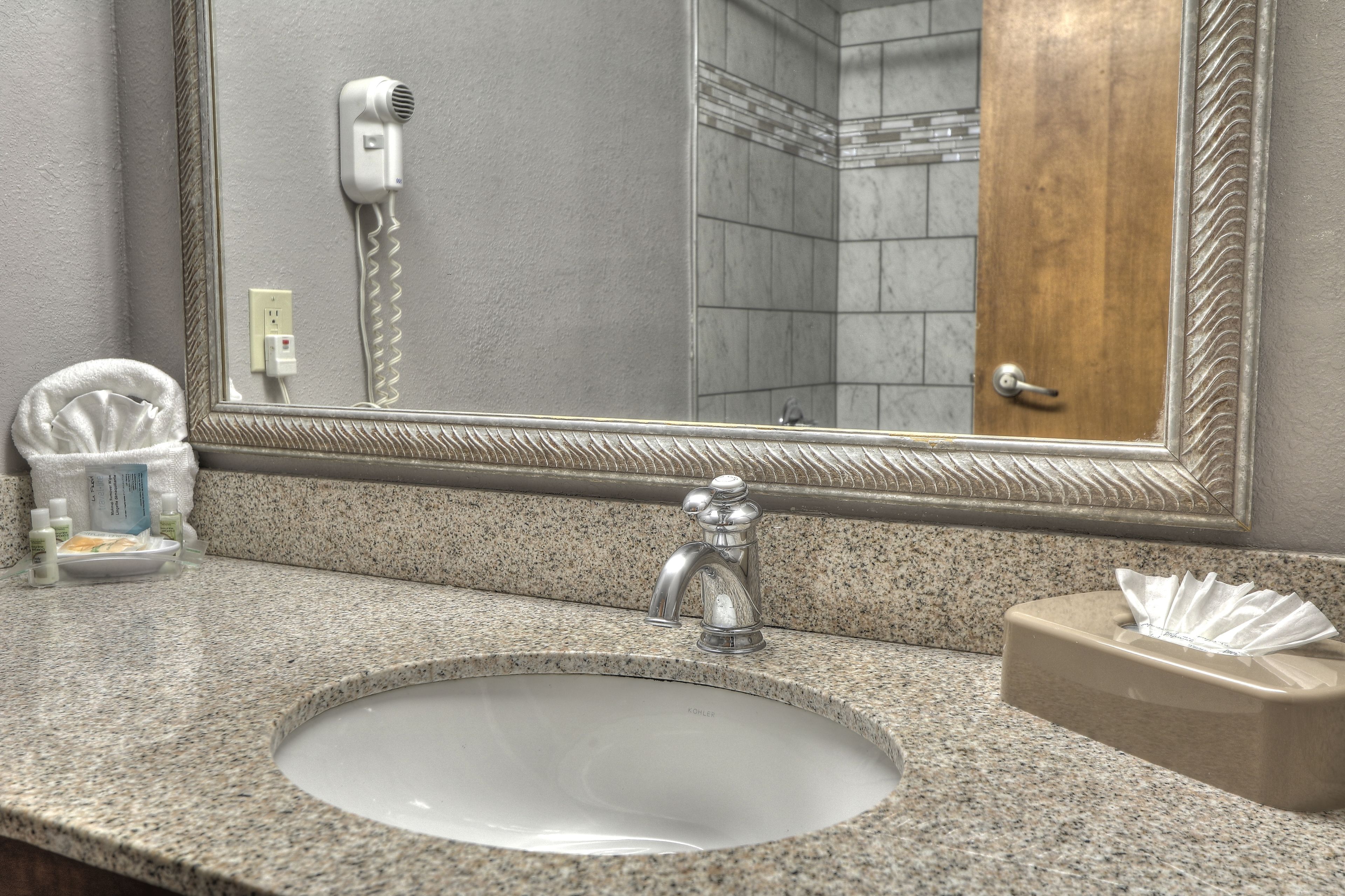 designer toiletries, hair dryer, towels, soap