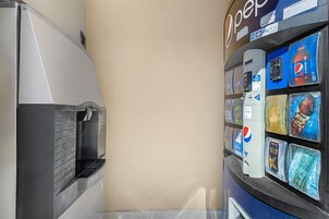A vending machine with various beverage options, including Pepsi and Mountain Dew, and a refrigerator with a beverage dispenser.