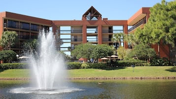 A hotel with a central courtyard, a fountain, and a swimming pool.