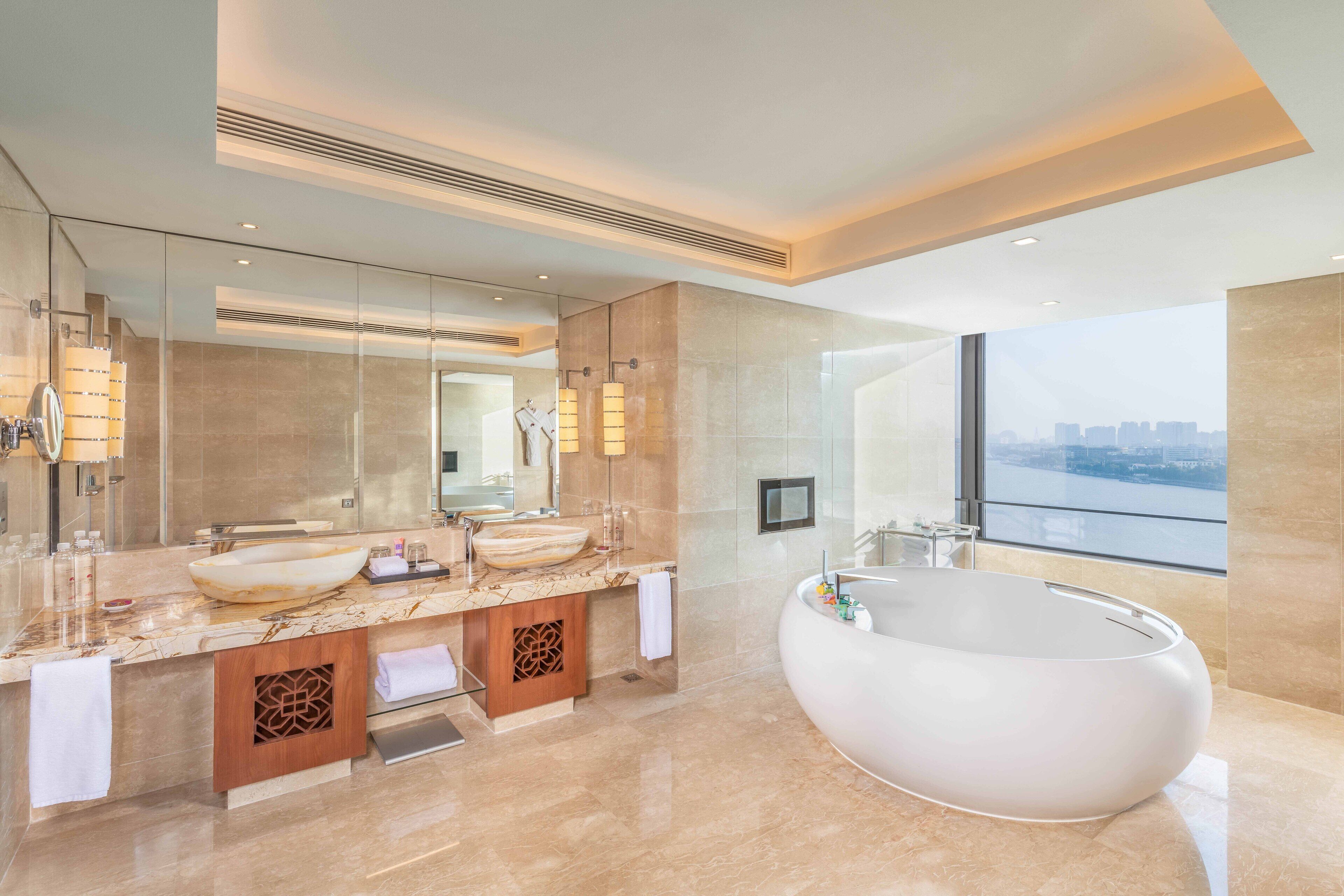 club premier suite river view king bed | bathroom | designer toiletries, hair dryer, bathrobes, slippers