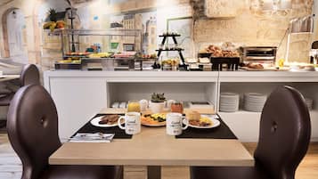 A breakfast buffet with various food items and a coffee station.