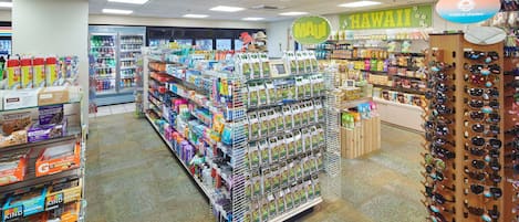 A grocery store with a variety of products on shelves, including snacks, beverages, and household items.