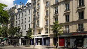 A multi-story hotel with balconies, a visible entrance, and signage for 'Monoprix' and 'hotel Libertel'. - Libertel Canal Saint Martin (Paris)