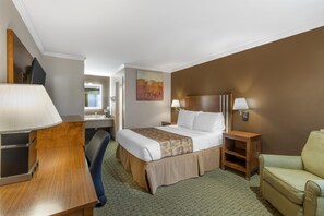 A hotel room with a bed, desk, chair, and a small seating area. - SureStay by Best Western Lakeview (Lakeview)