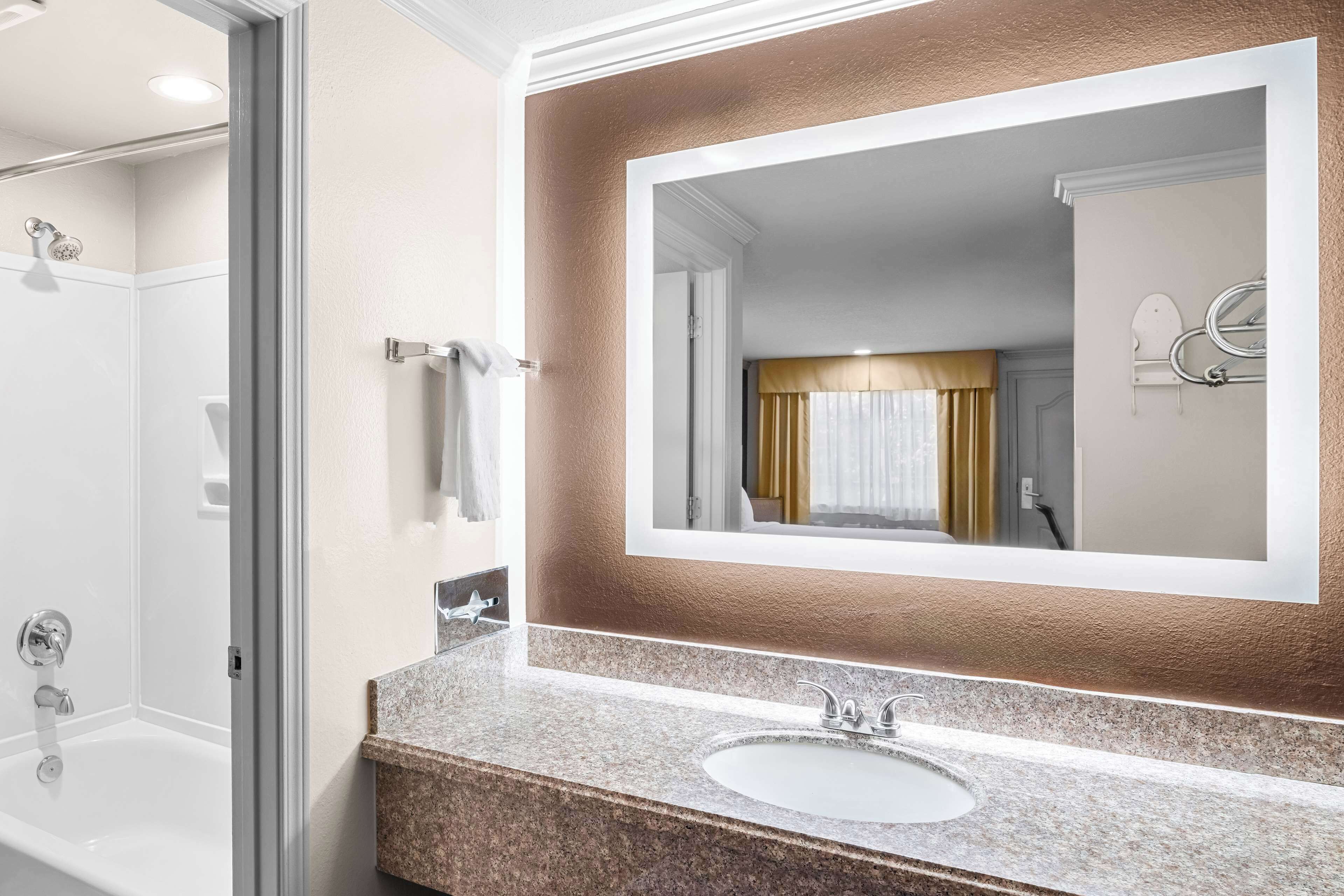 standard room, 2 queen beds, non smoking, refrigerator & microwave | bathroom | combined shower/bathtub, free toiletries, hair dryer, towels