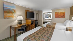 A hotel room with a desk, chair, two beds, a television, and artwork on the walls. - SureStay by Best Western Lakeview (Lakeview)
