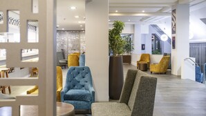 A modern lobby with seating areas, a reception desk, and a staircase. - Copthorne Hotel Palmerston North (Palmerston North)