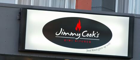 A restaurant signboard for Jimmy Cook's Kiwi Kitchen.