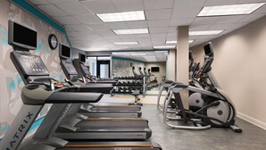 A gym with treadmills, elliptical machines, and weightlifting equipment. - Wyndham Sacramento (Sacramento)