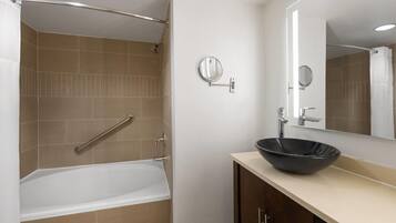 Deluxe Suite, 1 King Bed, Non Smoking | Bathroom | Combined shower/tub, hair dryer, towels, soap