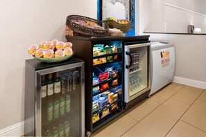 A vending machine area with snacks, beverages, and ice cream treats. - Wyndham Sacramento (Sacramento)