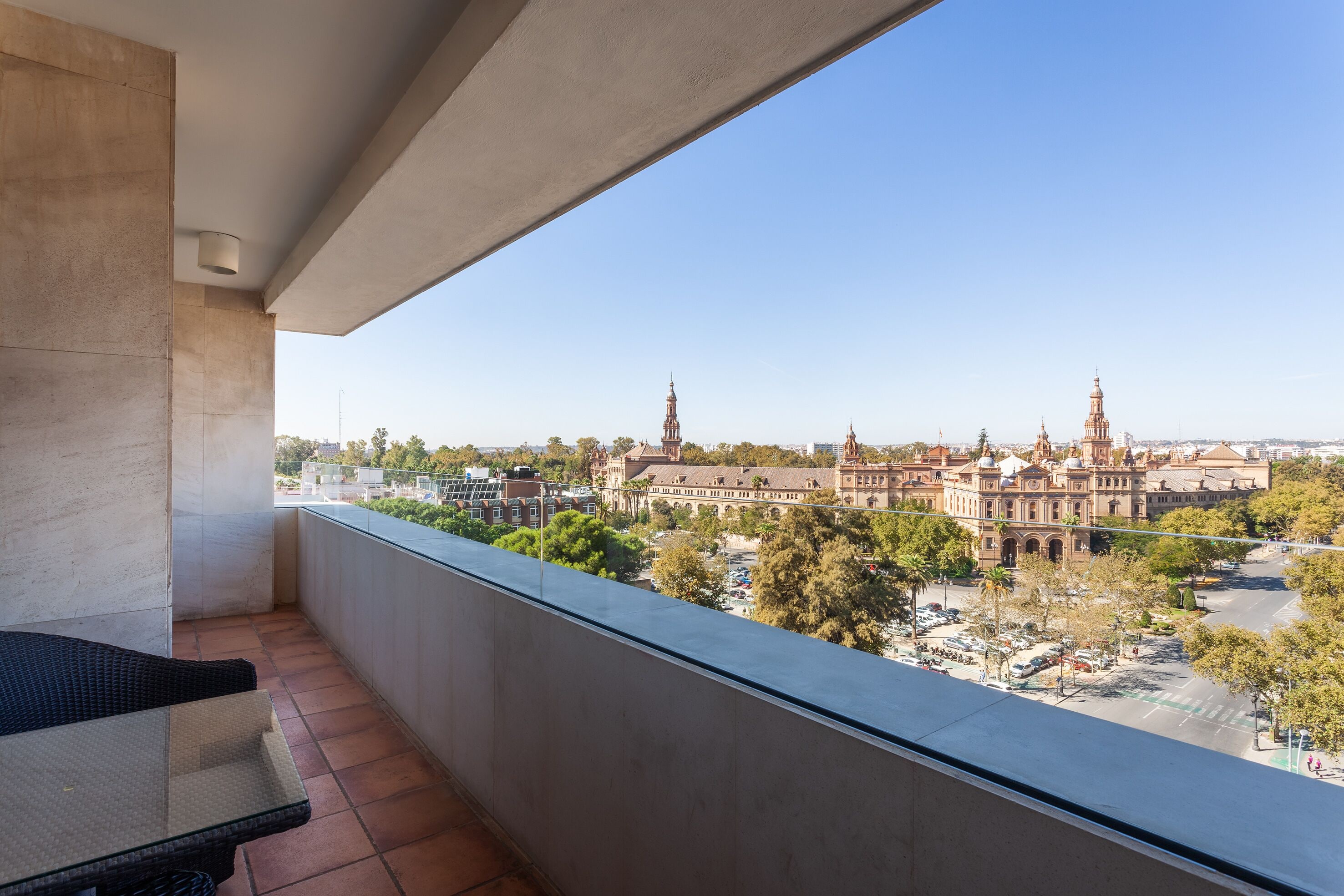 A balcony with a view of a historic building complex.