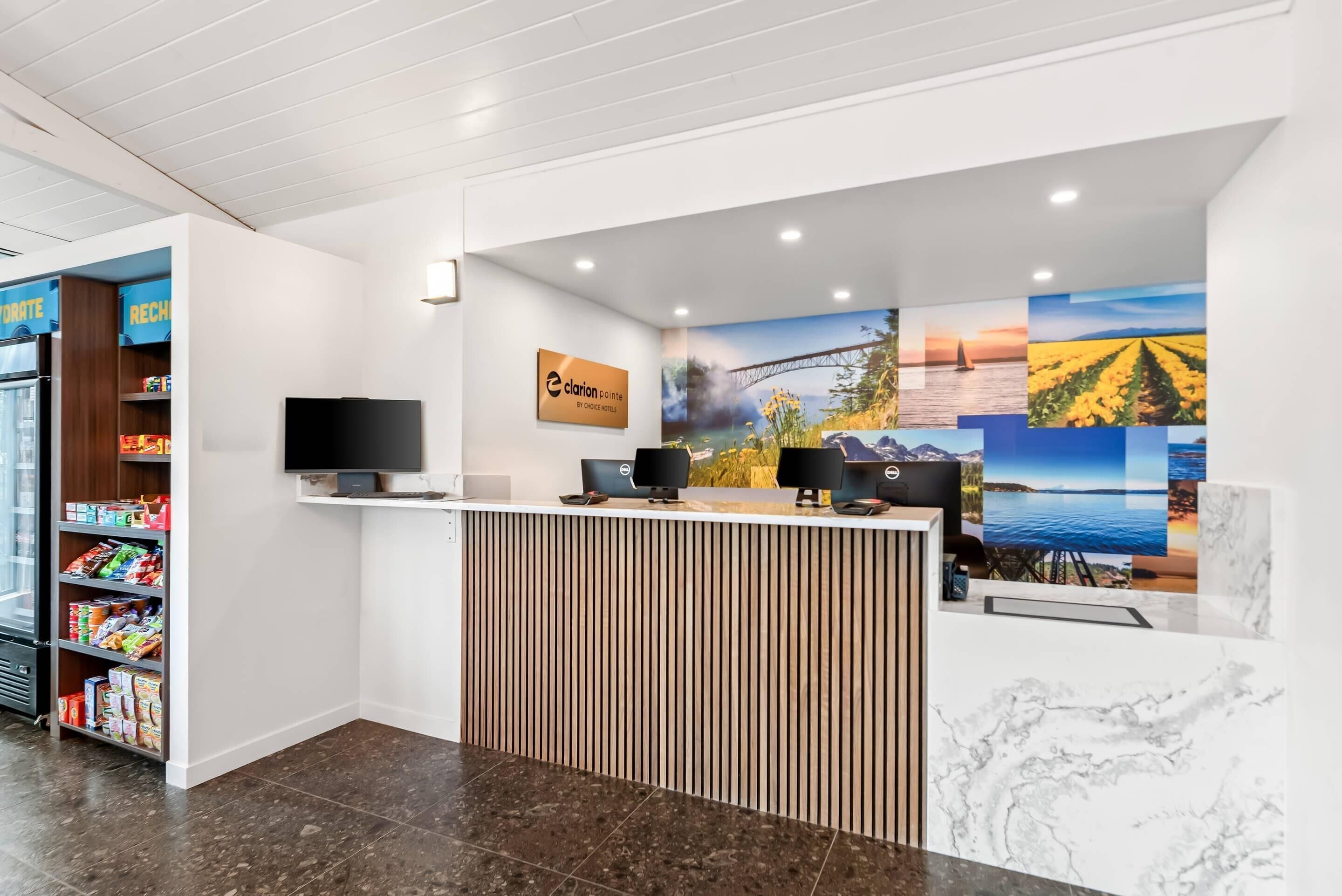 A reception area with a counter, a television, and a sign that reads "Clarion Point."
