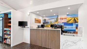 A reception area with a counter, a television, and a sign that reads "Clarion Point."