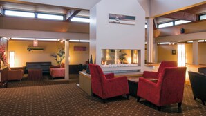 A spacious lobby with a fireplace, seating area, and a reception desk. - Copthorne Hotel Rotorua (Rotorua)