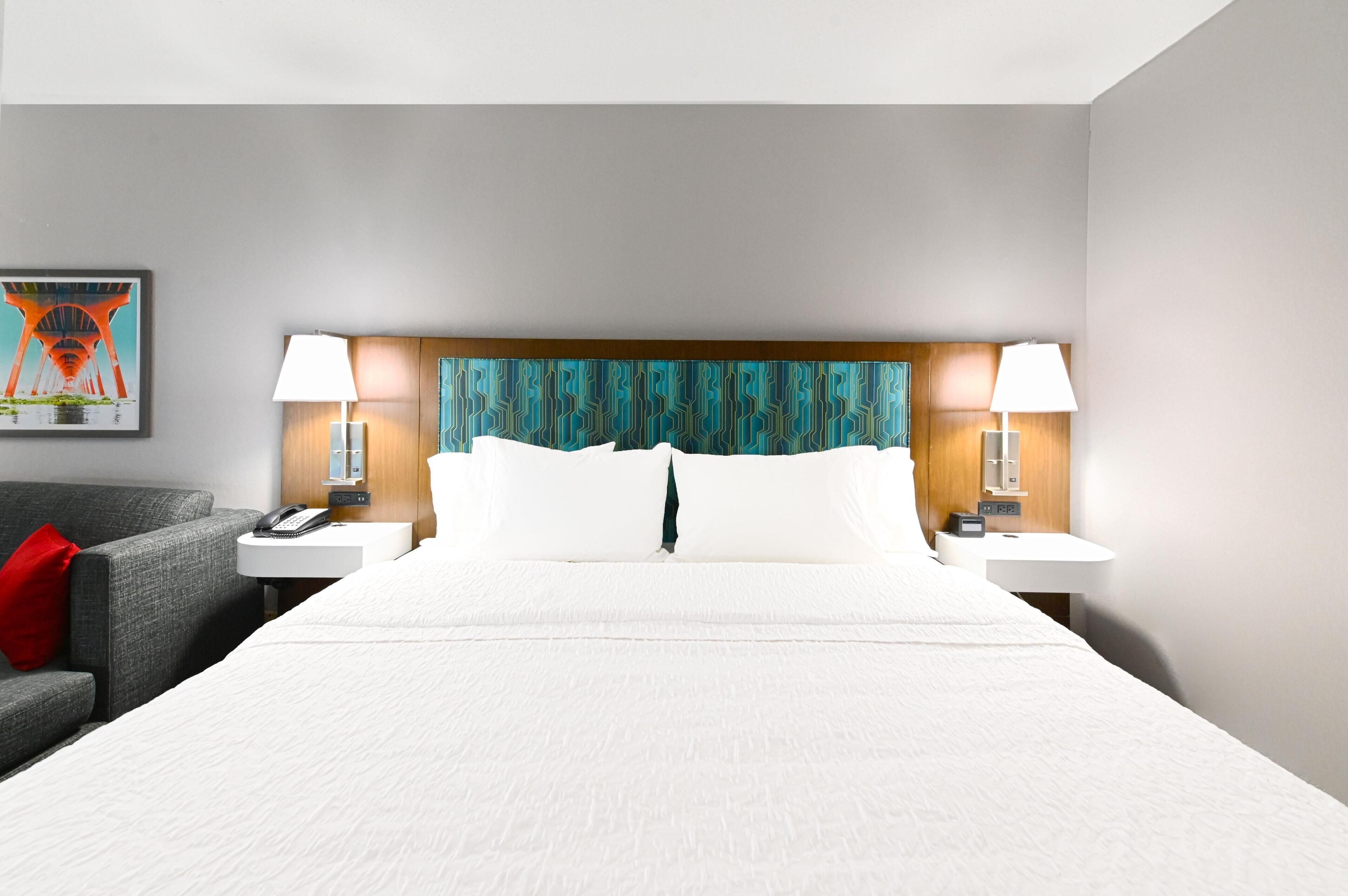 Premium bedding, desk, laptop workspace, blackout curtains