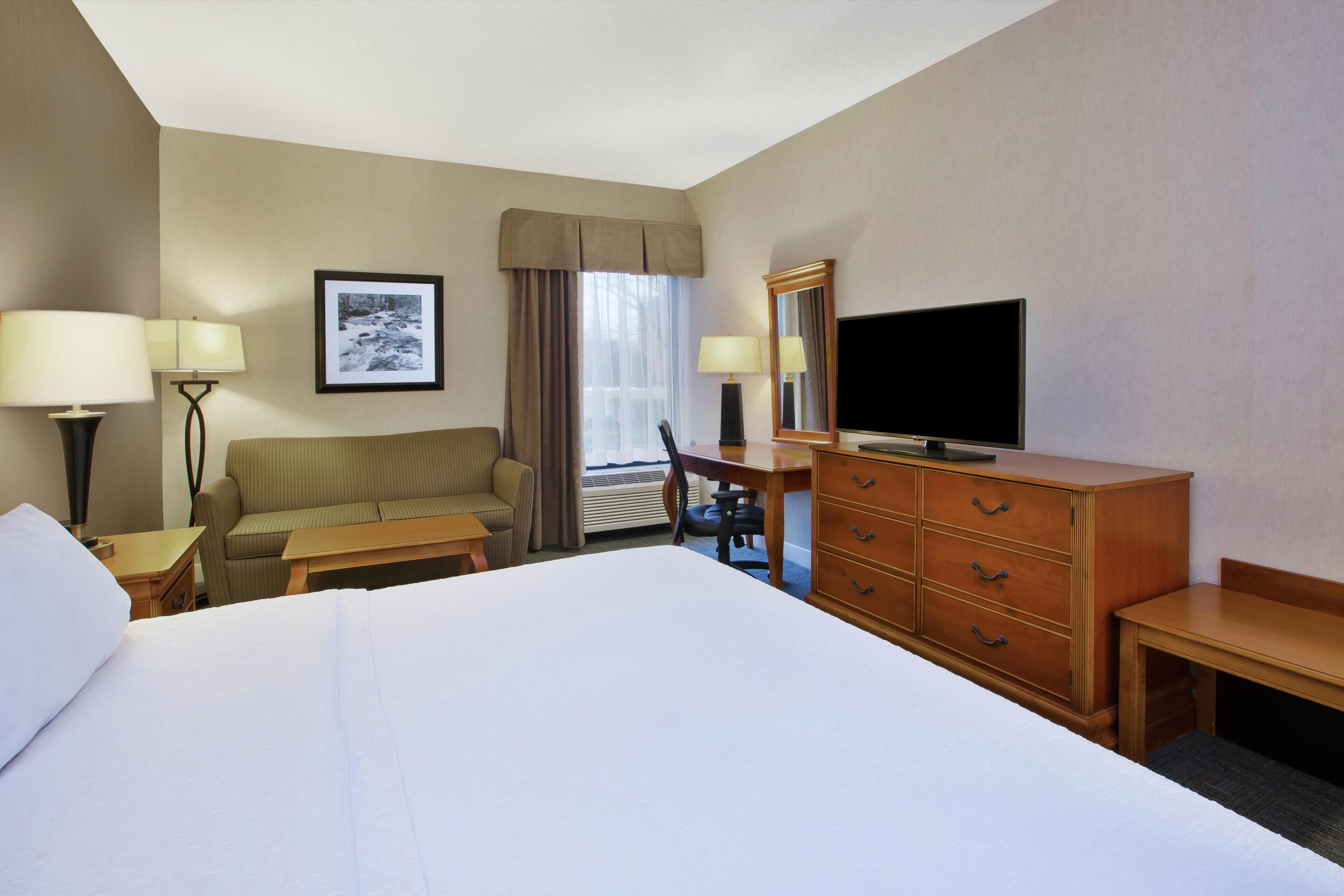 Premium bedding, desk, laptop workspace, blackout drapes