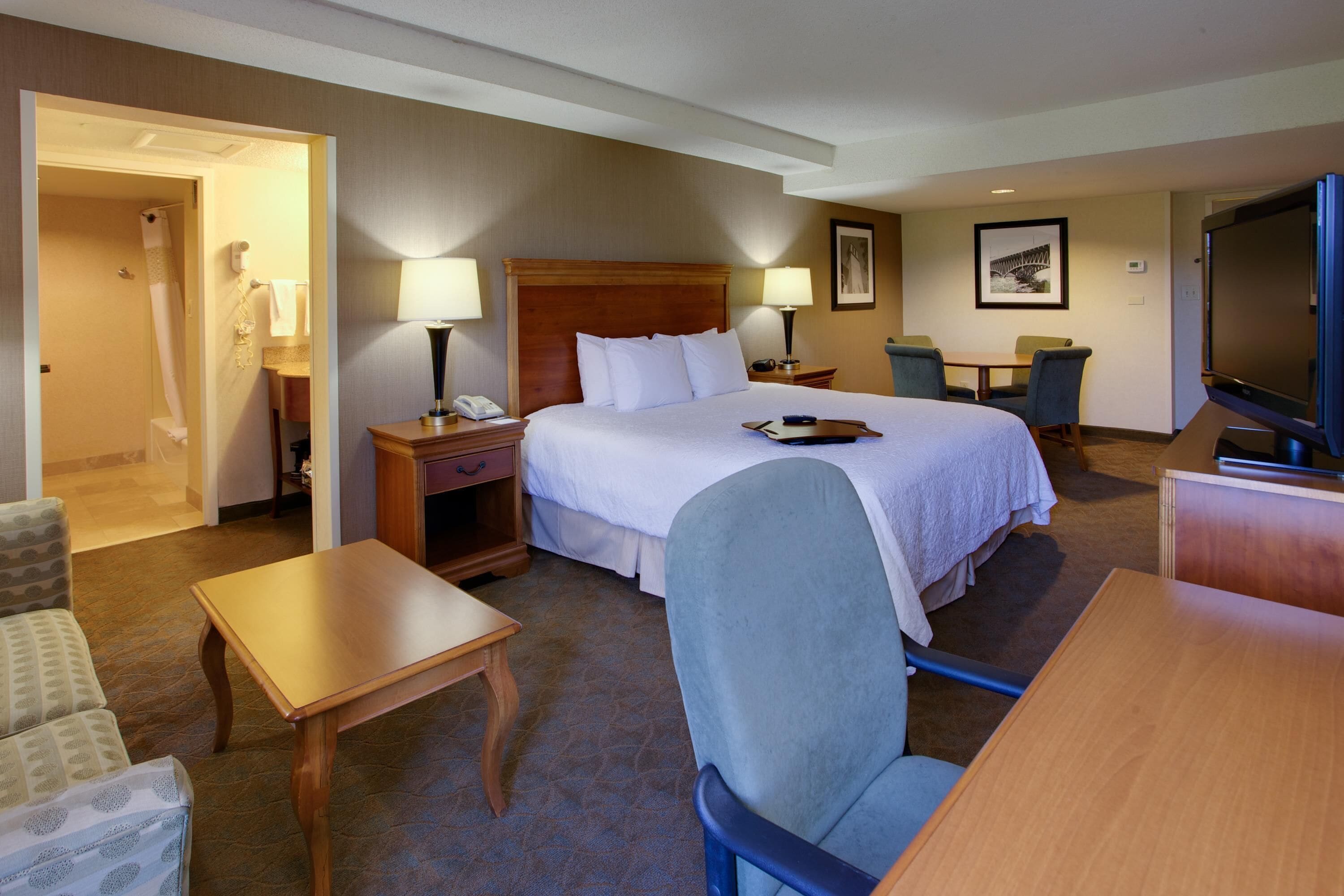 Premium bedding, desk, laptop workspace, blackout drapes