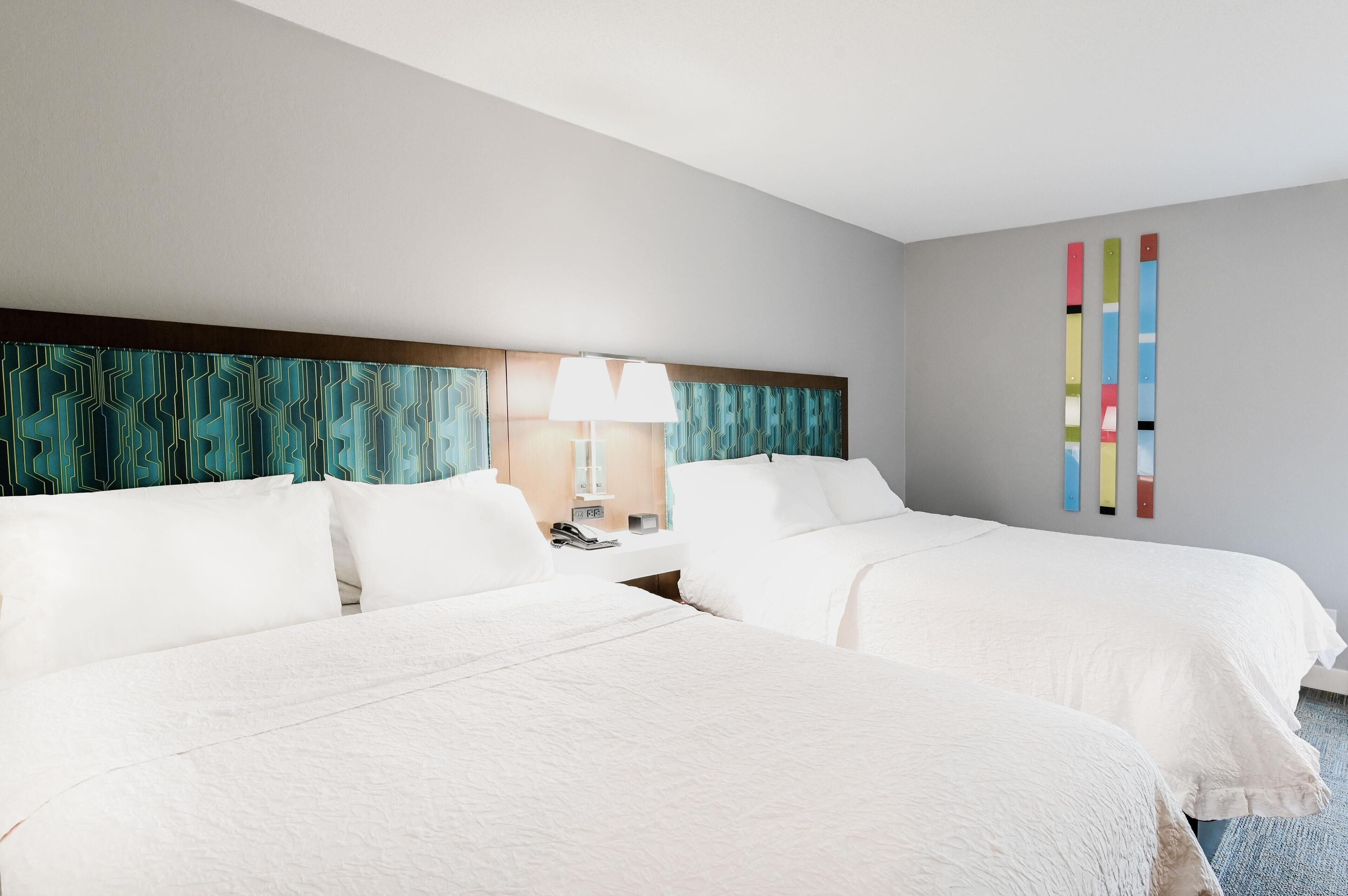 Premium bedding, desk, laptop workspace, blackout drapes