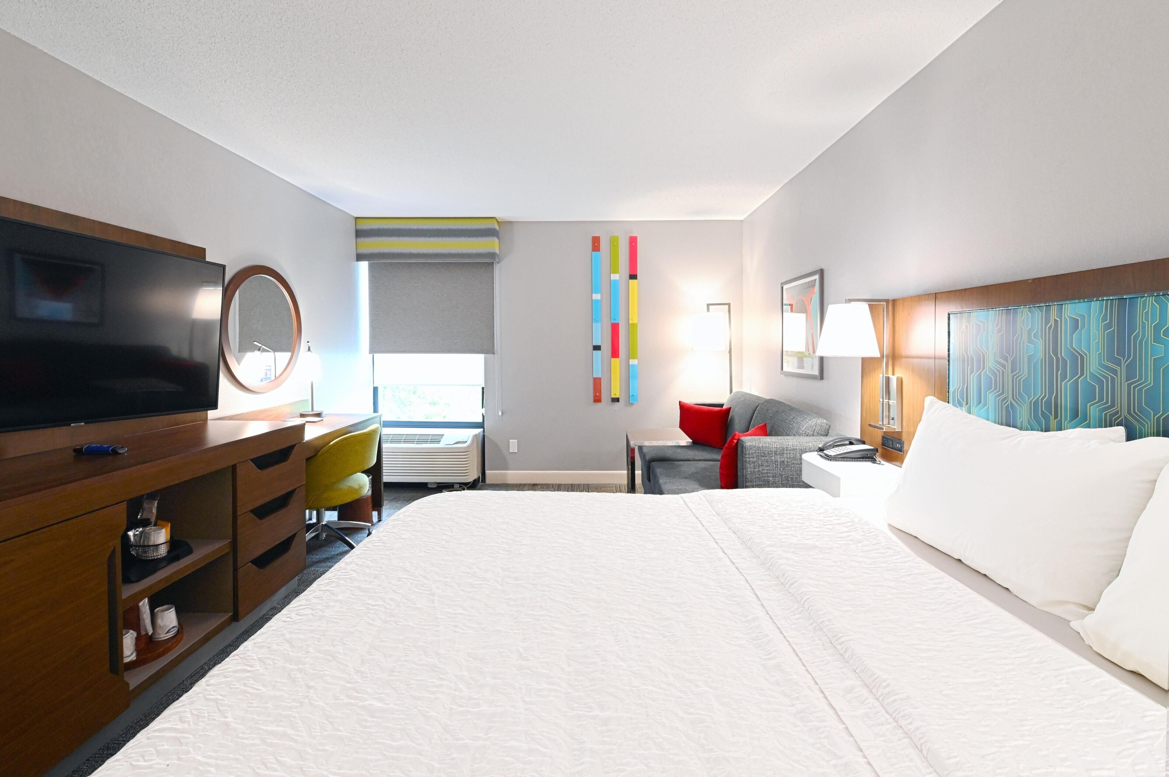 Premium bedding, desk, laptop workspace, blackout drapes