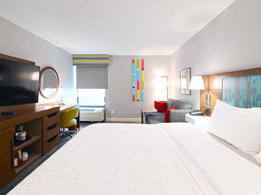 Premium bedding, desk, laptop workspace, blackout drapes