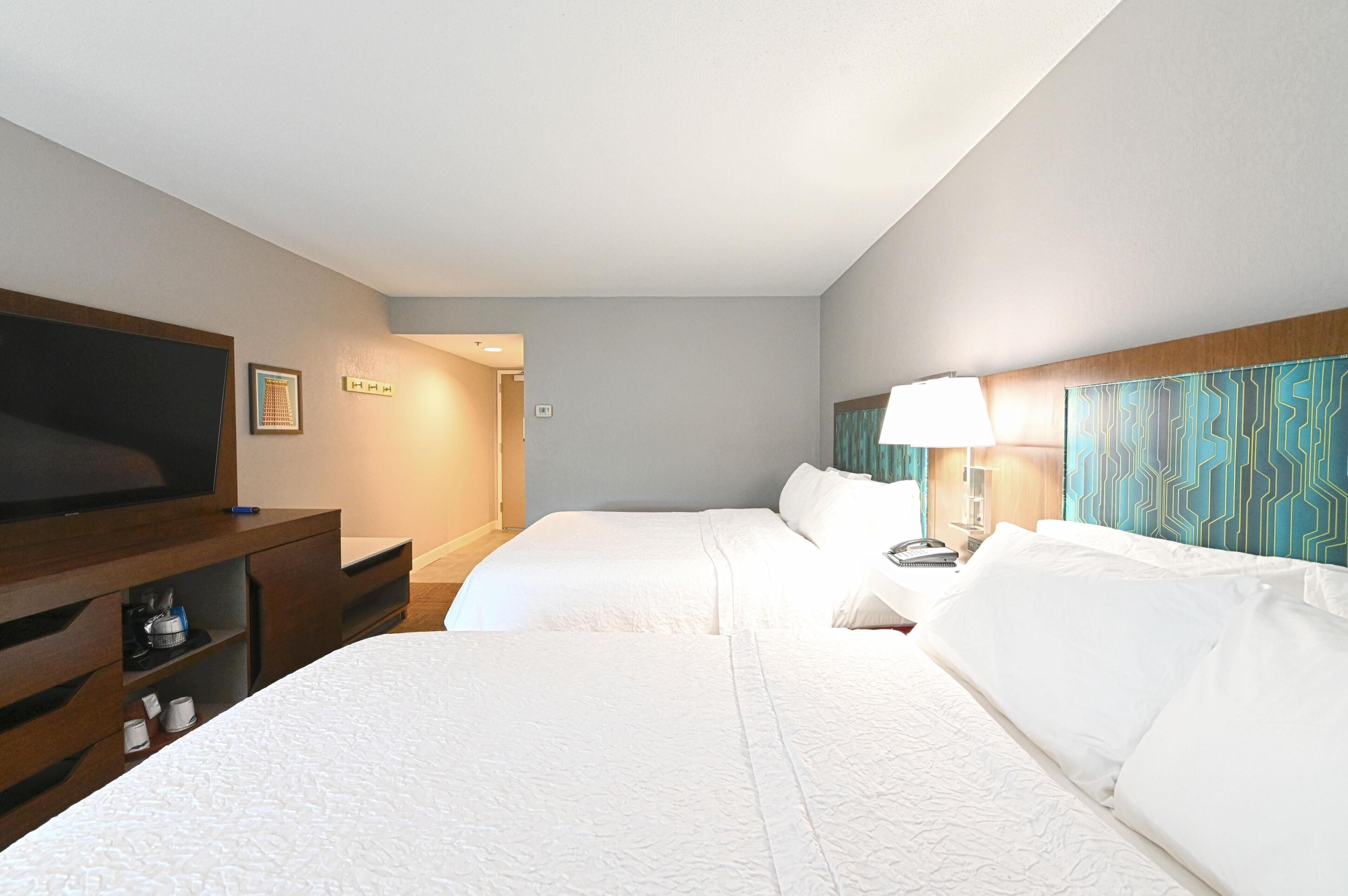 Premium bedding, desk, laptop workspace, blackout curtains