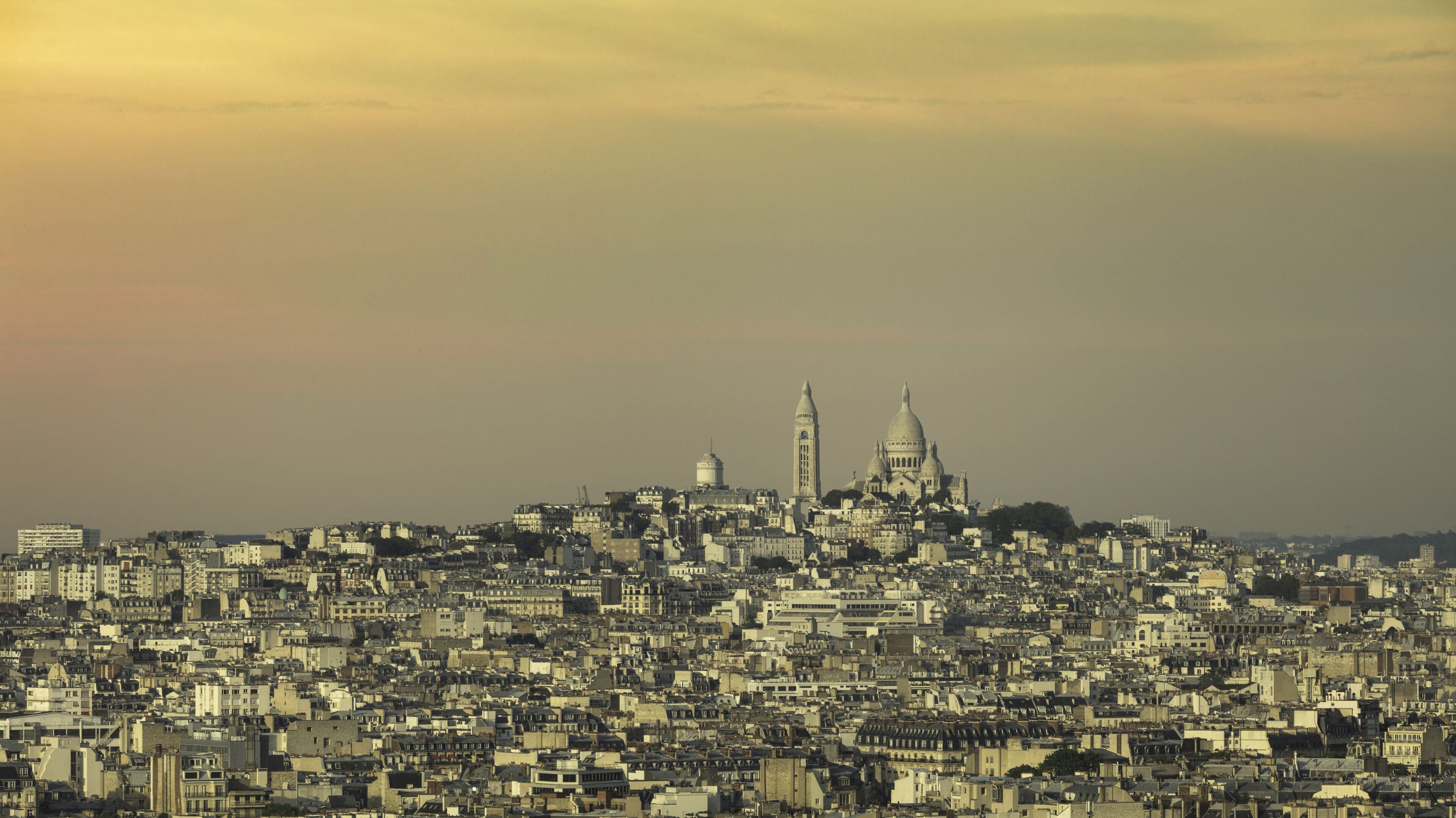 Un paisaje urbano con edificios densos, una catedral destacada con dos torres y una cúpula.