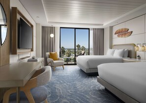 A hotel room with a large bed, a desk, a chair, a TV, and a view of the ocean. - Hotel La Jolla, Curio Collection by Hilton (La Jolla)