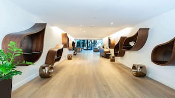 A modern spa with wooden curved seating and a central relaxation area.
