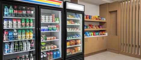 A refrigerated display case with various beverages and snacks.
