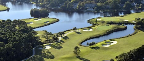 A golf course with multiple water hazards and sand bunkers.