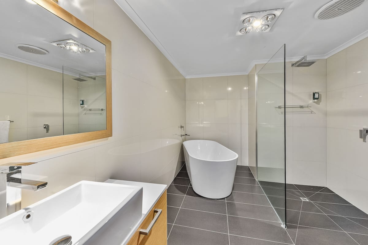 premier room, 1 king bed | bathroom | shower, eco-friendly toiletries, hair dryer, towels