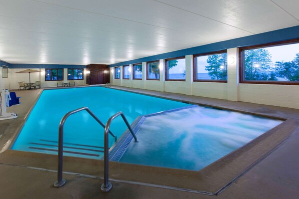 Relax by the pool with a serene view of the surrounding landscape.