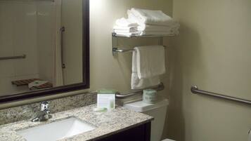 A bathroom with a sink, mirror, towel rack, and toilet.