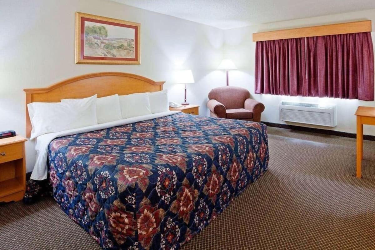 Desk, laptop workspace, blackout drapes, iron/ironing board