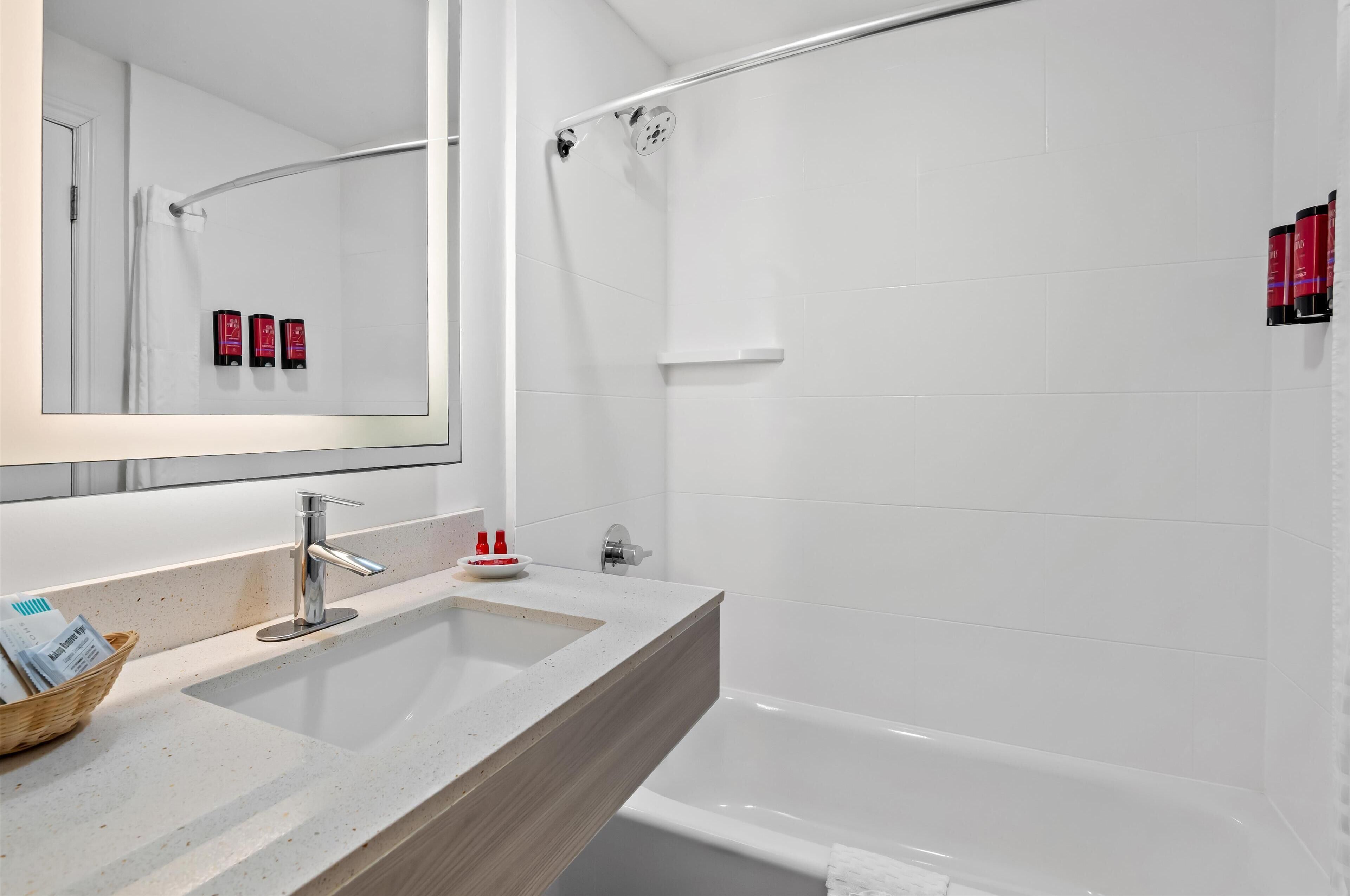 standard room, 2 queen beds, refrigerator & microwave, courtyard area | bathroom | hydromassage showerhead, eco-friendly toiletries, hair dryer, towels